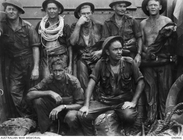 TARAKAN, BORNEO. 1945-04-30. MEN OF 2/13 FIELD COMPANY, ROYAL AUSTRALIAN ENGINEERS, EXHAUSED AFTER THE INITIAL ATTEMPT TO GET ASHORE AT LINGKAS TO BLOW WIRE DEFENCES. THEY REST IN A LANDING CRAFT VEHICLE-PERSONNEL BEFORE A LATER SUCCESSFUL ATTEMPT AT FULL TIDE. IDENTIFIED PERSONNEL ARE:- SAPPER J.F. WILLIAMS (1); SAPPER J.R. MUNRO, LATER KILLED IN ACTION ON SNAG'S TRACK (2); SAPPER J.A. HOFFMANN (3); SAPPER R.A.R. STEVENSON (4); LANCE-CORPORAL R.C. MACE (5); SAPPER D.R. BIDWELL (6); SAPPER C.J. FOLEY (7). (Australian War Memorial ID #090906)