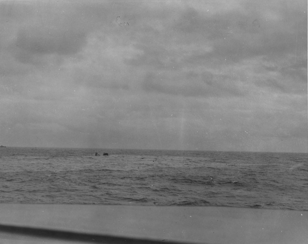 24 April 1945 - The USS Frederick C. Davis (DE-136) sinkin in the water of the North Atlantic after being hit by torpedo from the German sub U-546. Taken by a photographer of the USS Core (CVE-13) aboard the USS Neunzer (DE-150). (U.S. Navy Photo No. 323039)