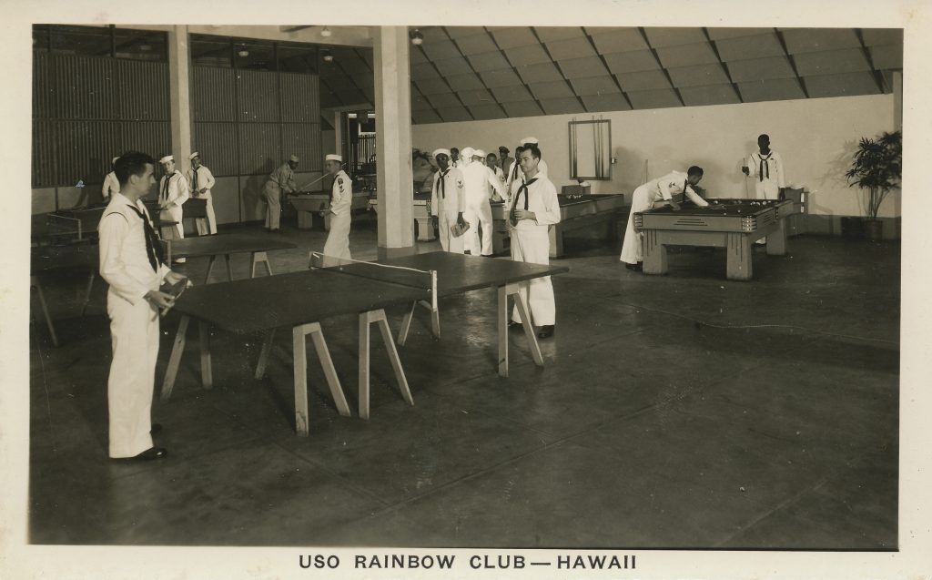 Sailors play ping-pong and shoot pool in the game room of the Rainbow Club.